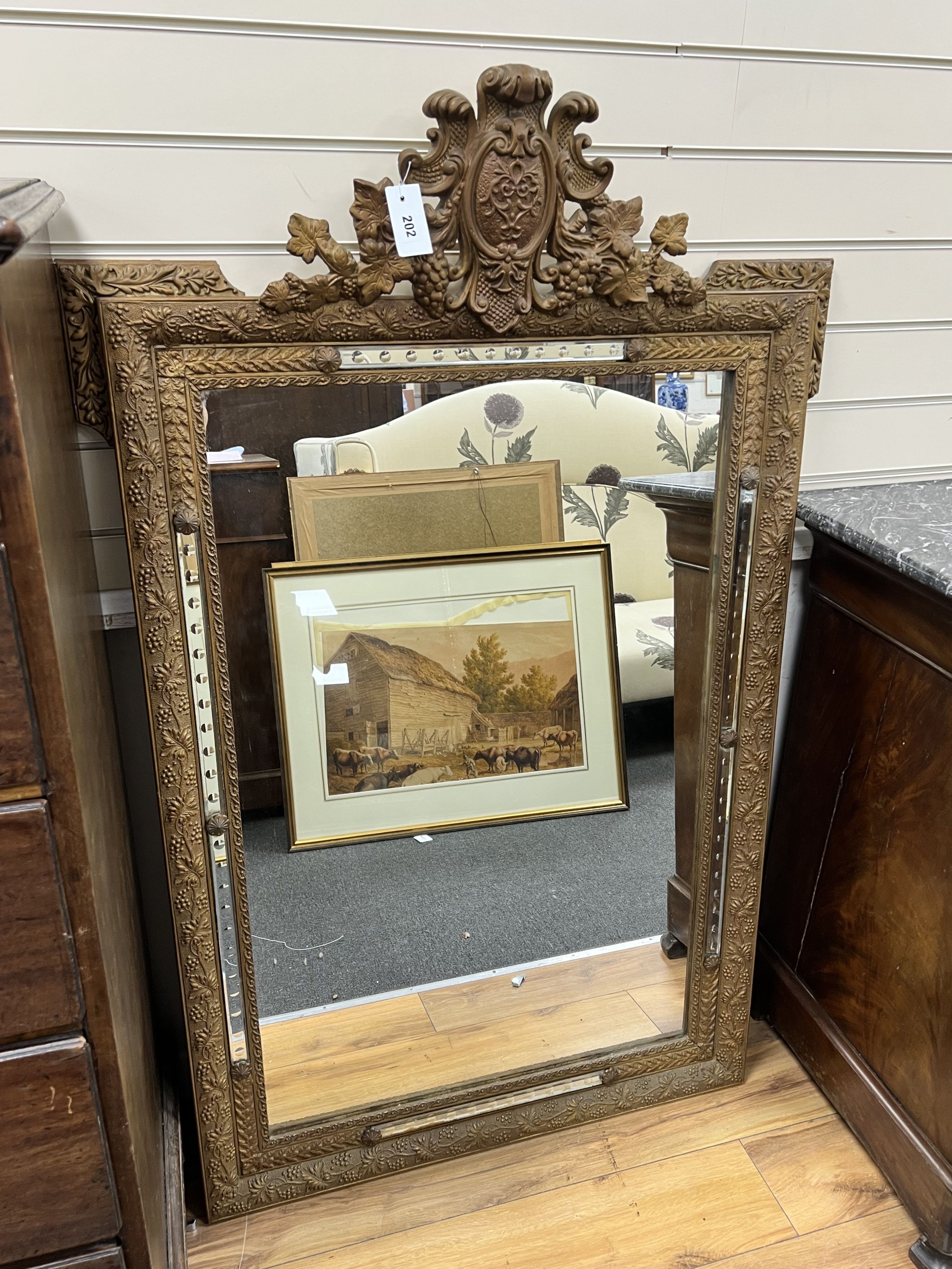 A late 19th century French giltwood and gesso overmantel mirror, with marginal plates, width 90cm height 140cm